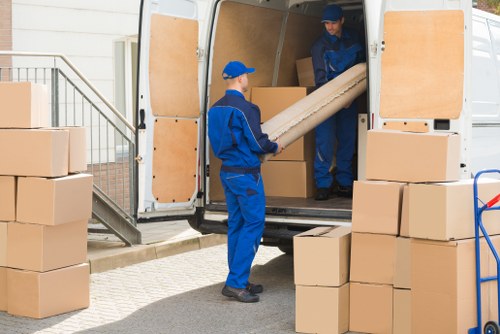Removal van and moving boxes in a Croydon street