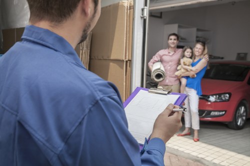 Removal team loading household items into a van